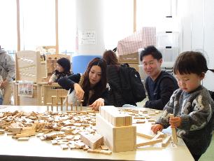 木のおもちゃで遊ぶ親子