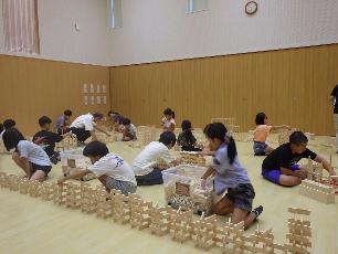 手分けして積み木を積んでいる小学生